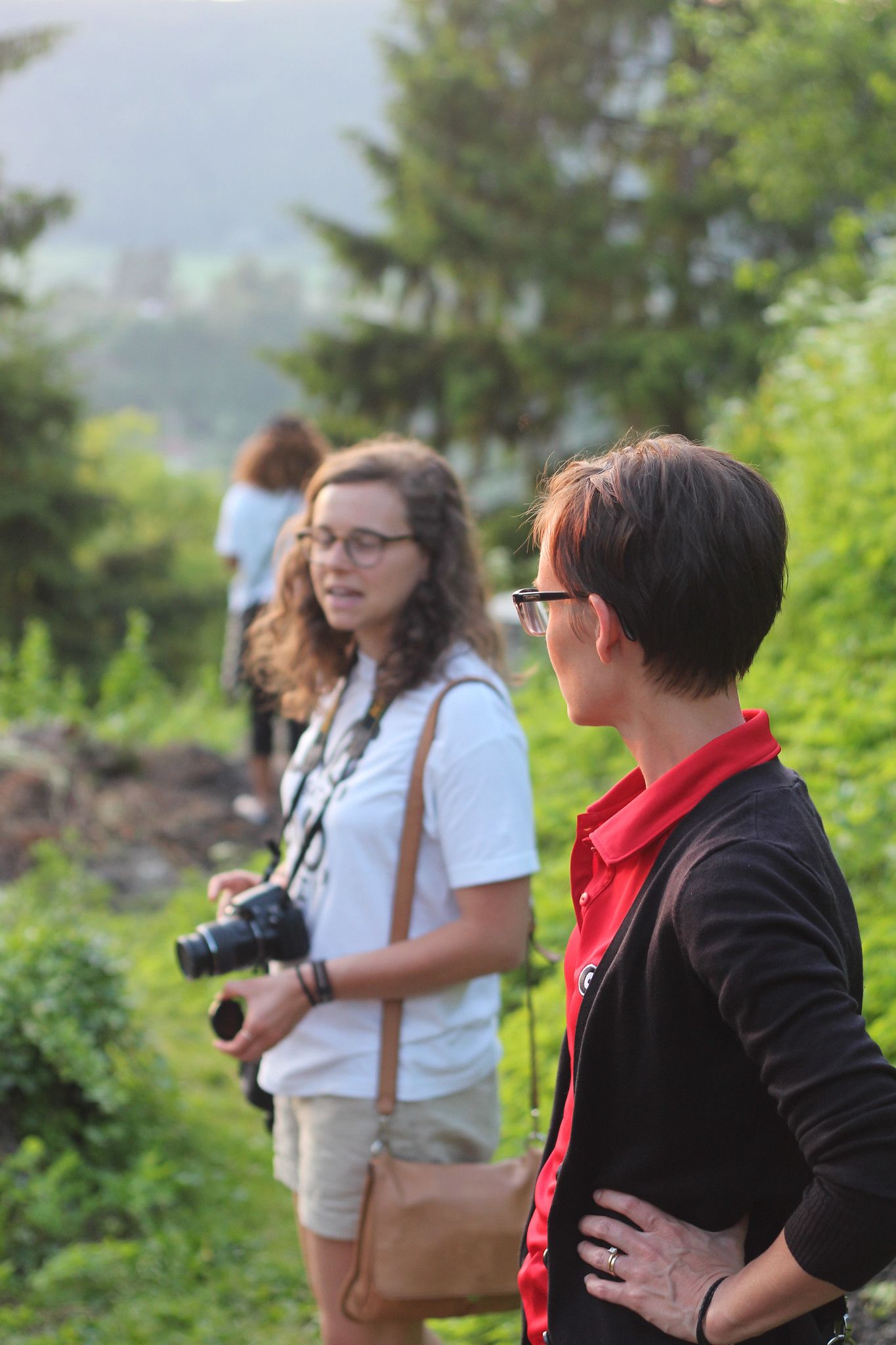 Borron looks at a student as they prepare to photograph nature scenes in Romania.