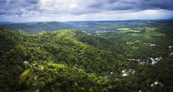 Lush, green hills under a cloudy sky