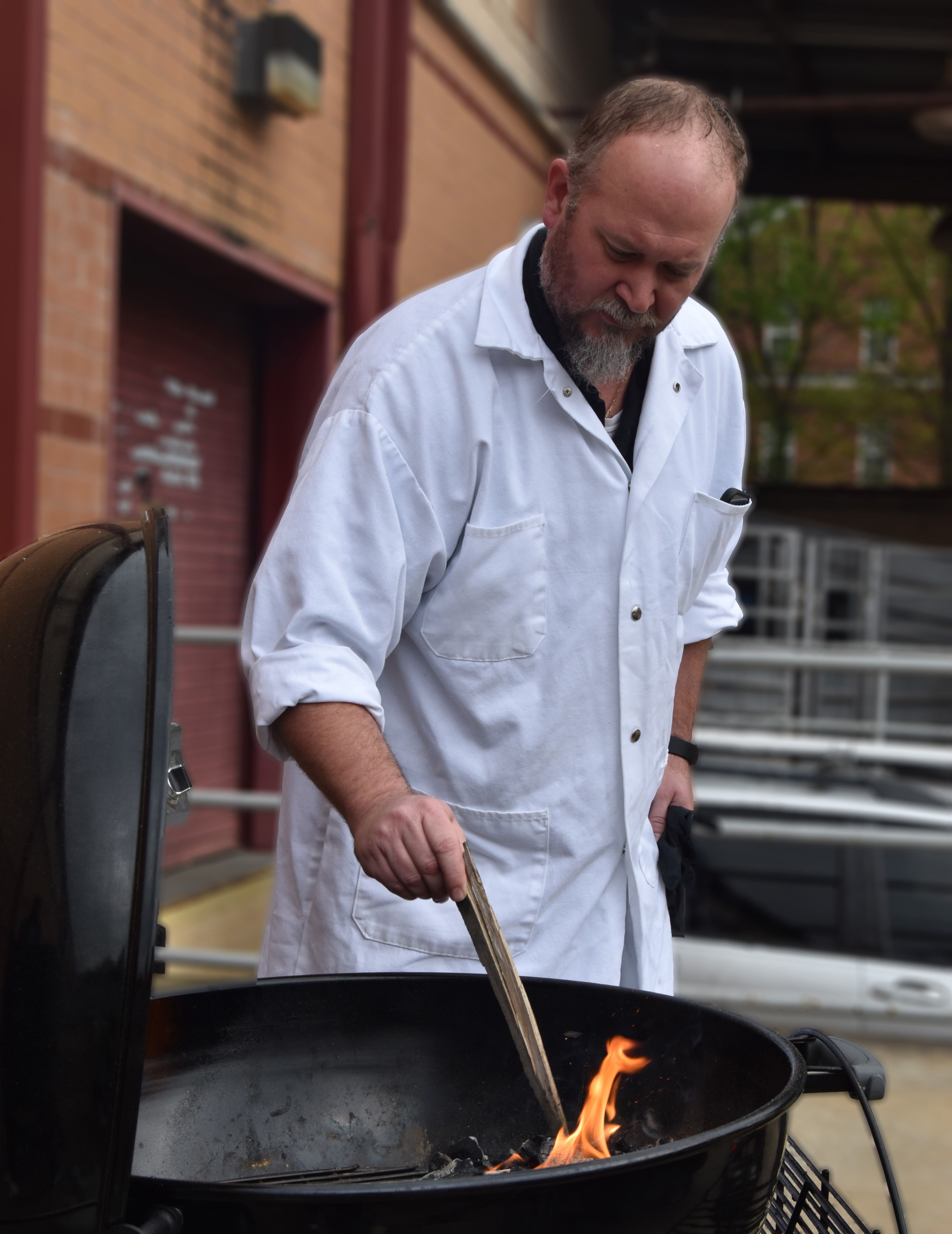 Stelzleni prepares the grill before adding the steaks.