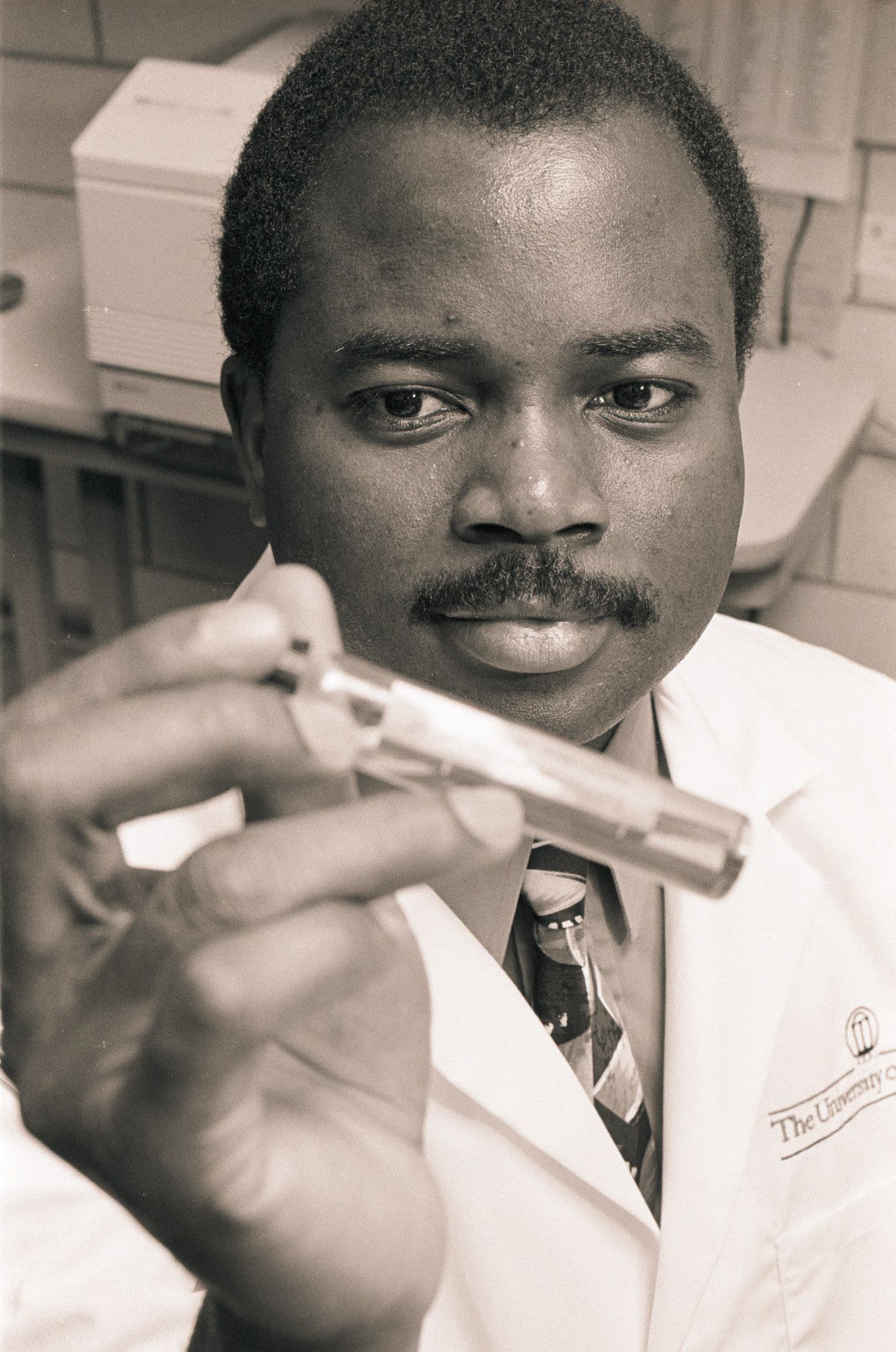 Akoh studies a vial in this 1993 lab photo