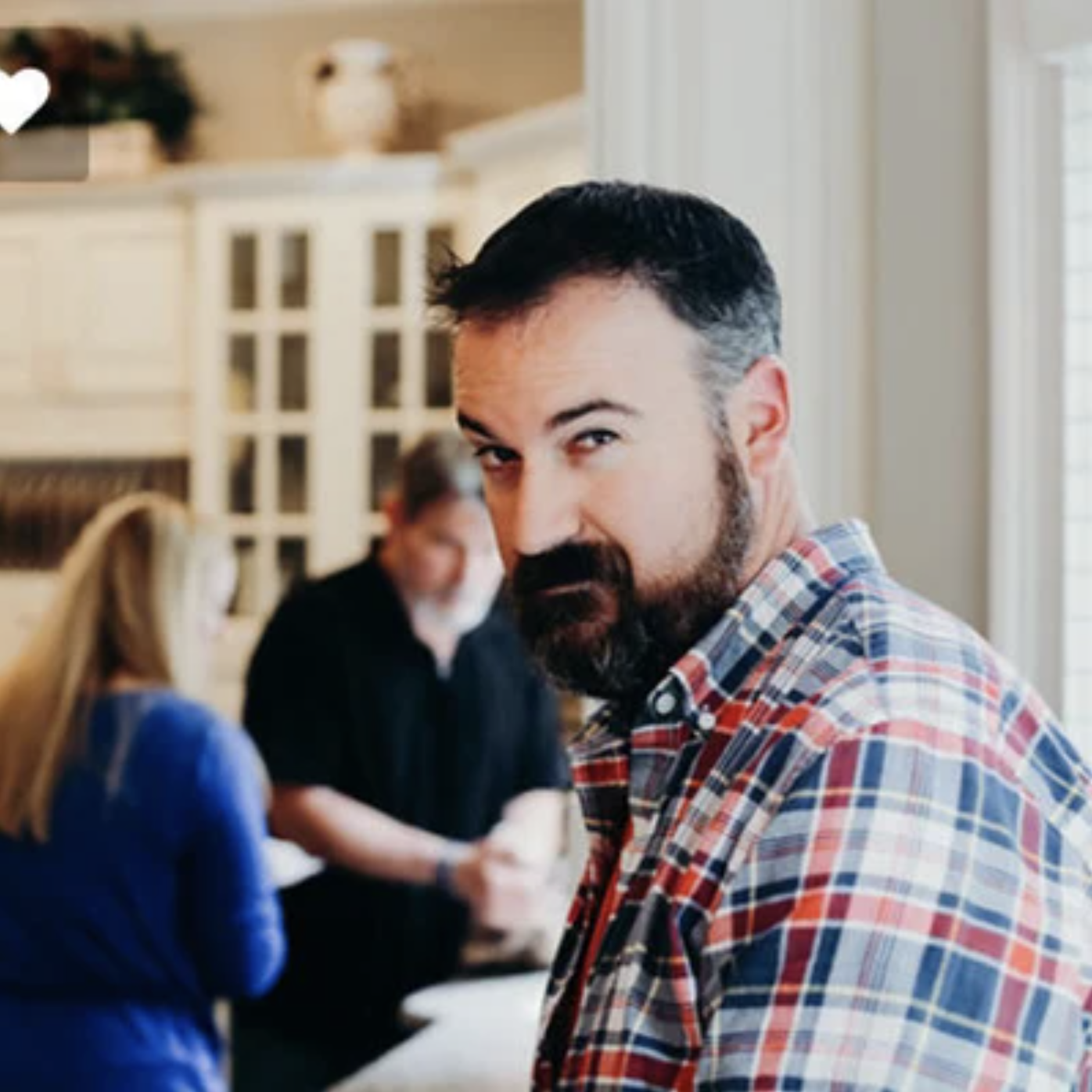 Craig Ganssle raises an eyebrow at the camera while in a social setting