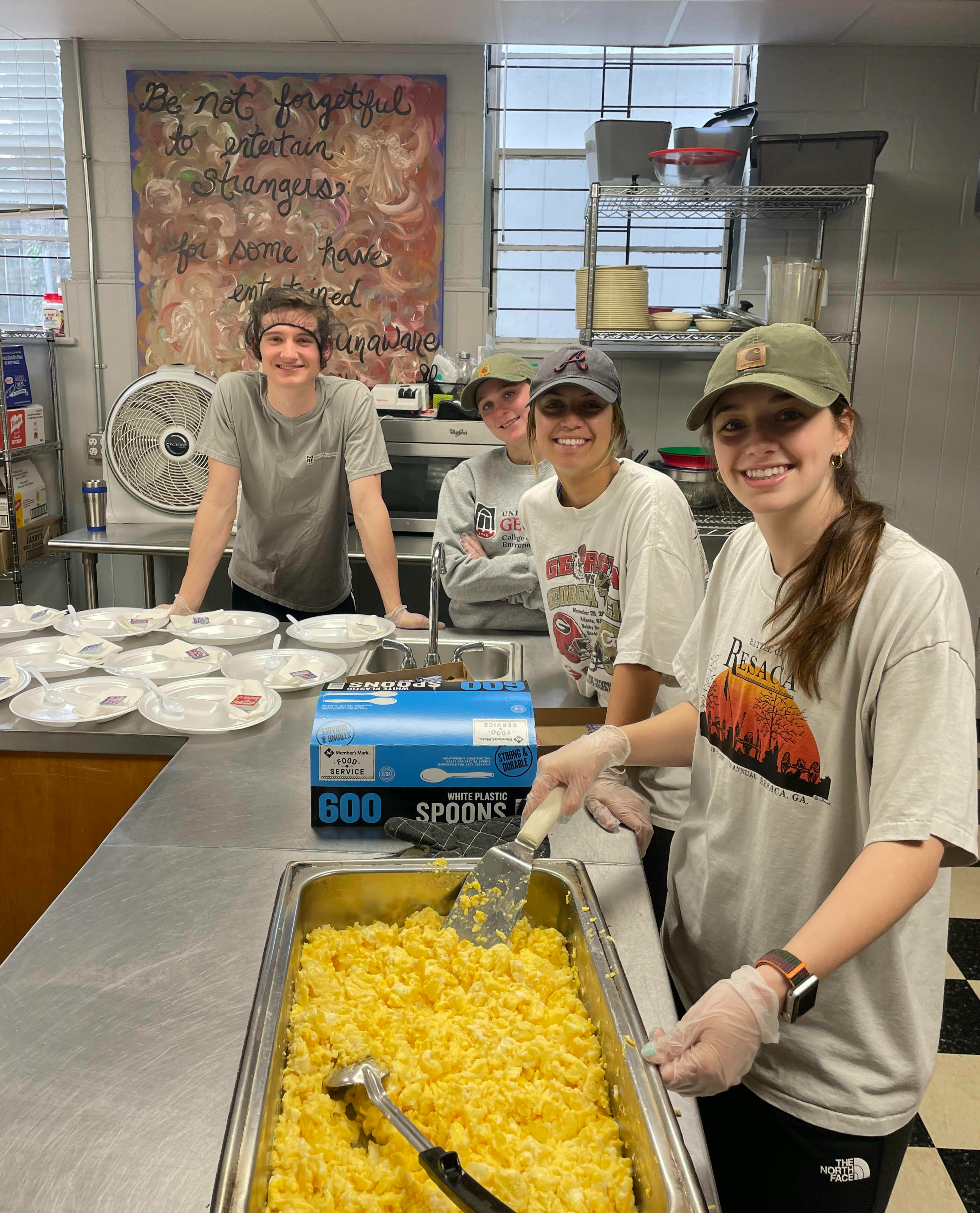 Students prepare food in an industrial kitchen