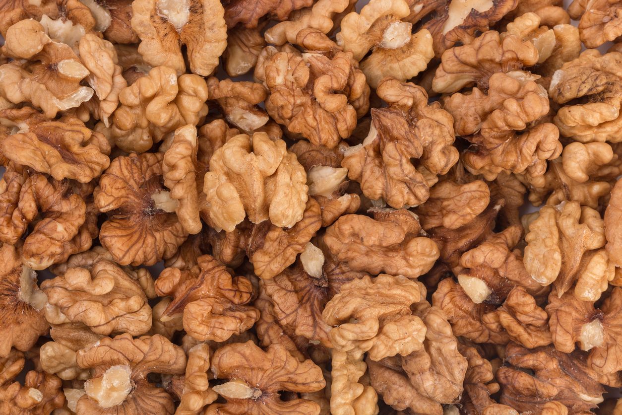 a close up of a pile of shelled walnuts creating a background
