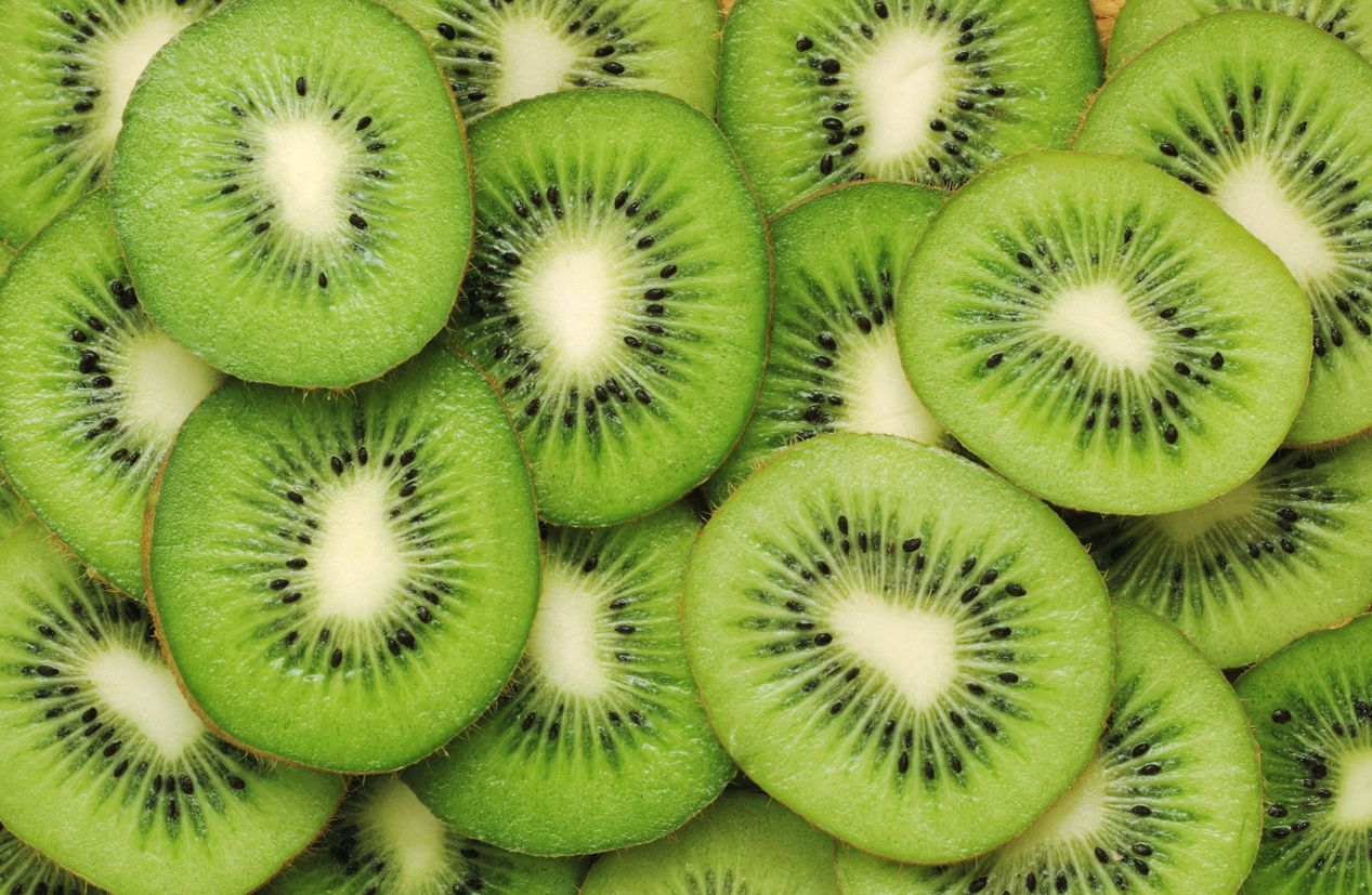 a close up of stacked kiwi slices covering the screen
