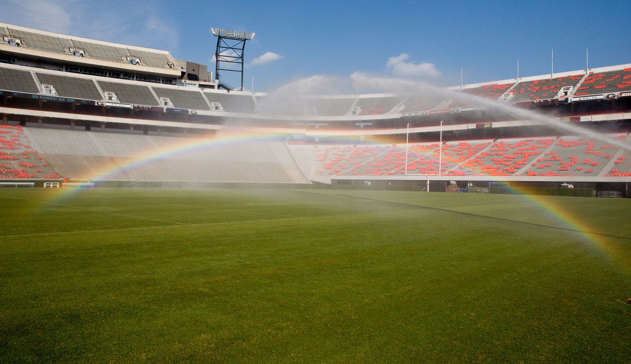 A rainbow shines over Sanford Stadium's sprinkler system