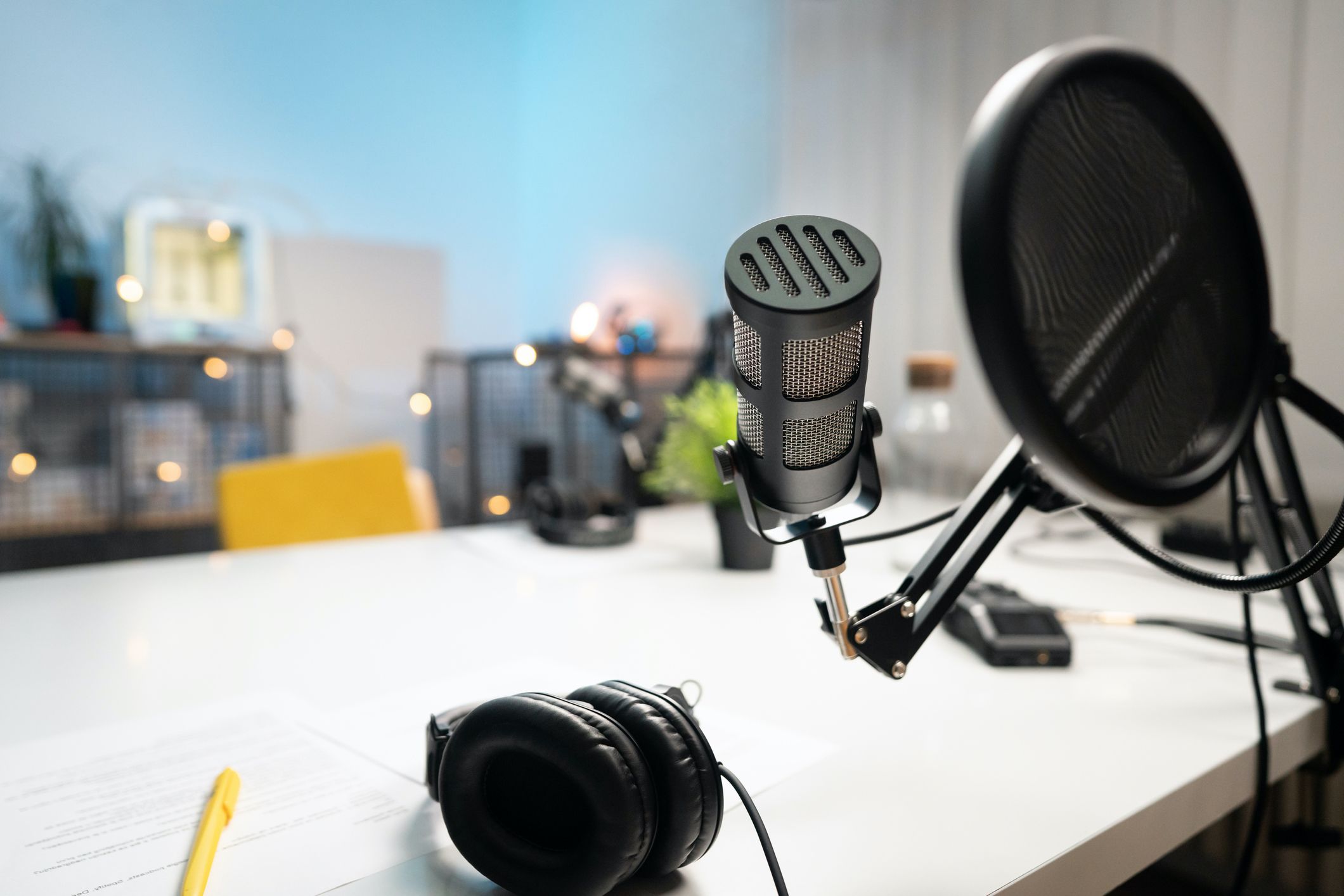 Podcast studio with equipment and microphone in the foreground