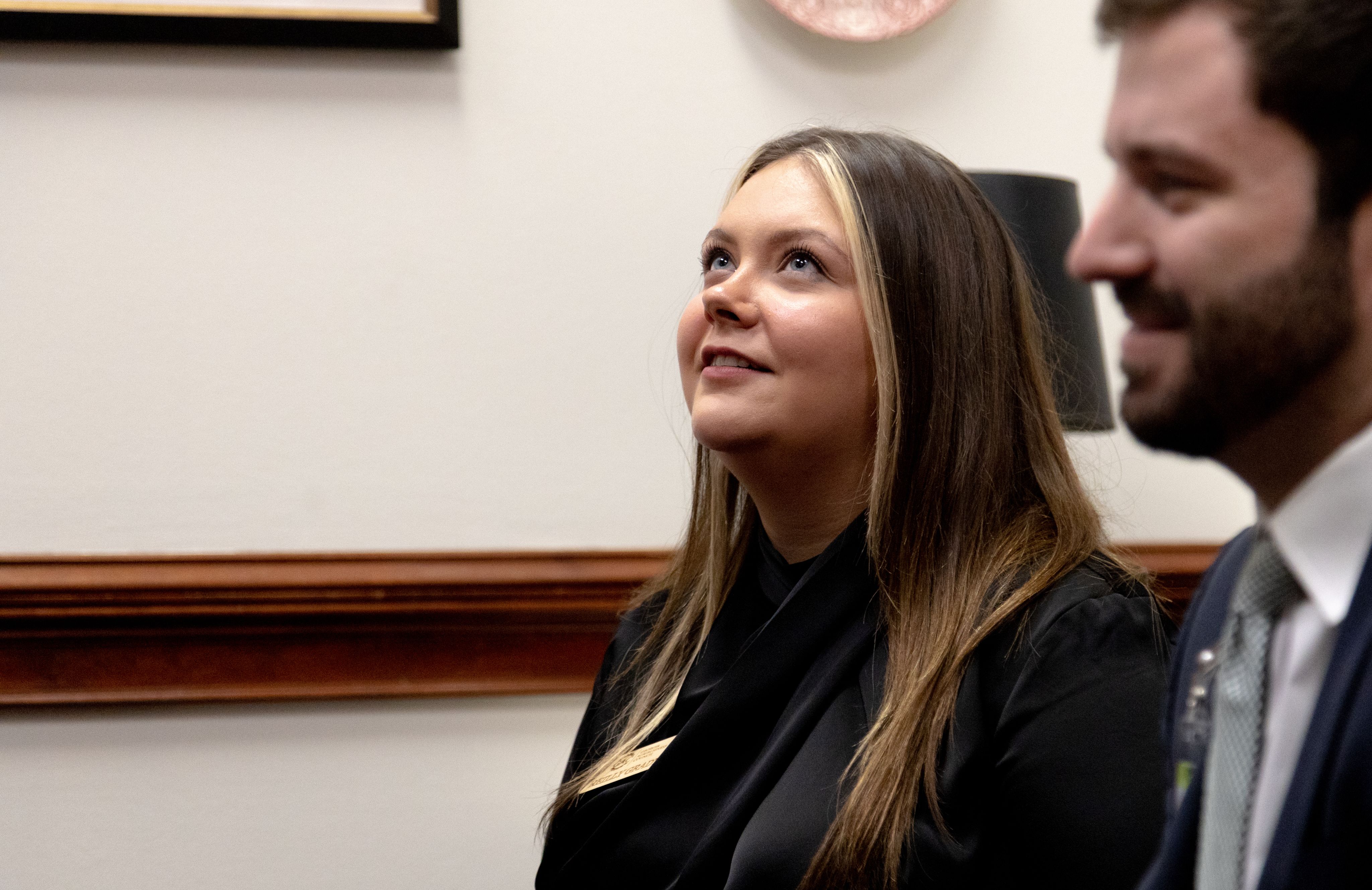 Reilly Grady looks up at a colleague in the Georgia Capitol
