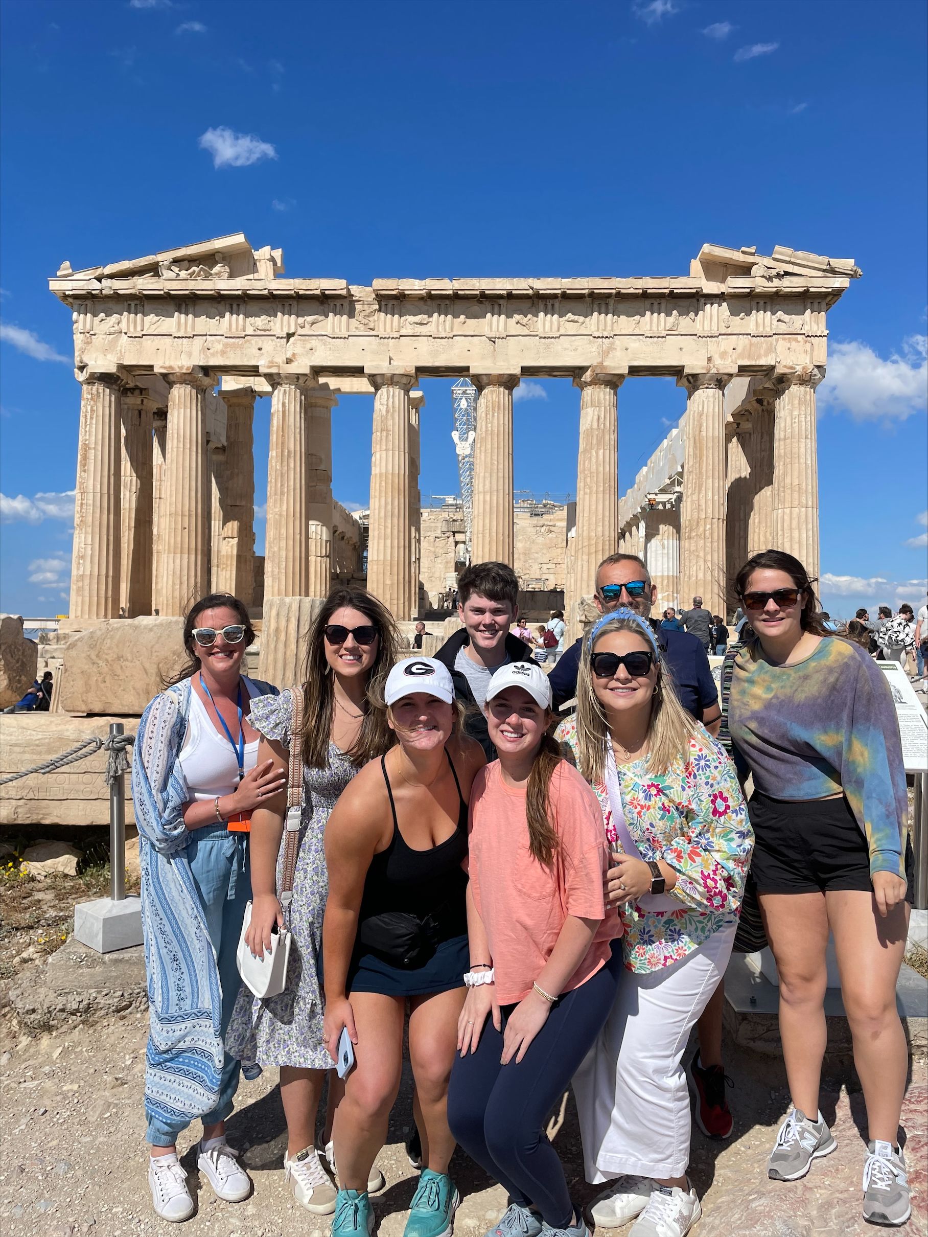 The CAES students on the trip gather with Professor Gene Kostandini and CAES Chief Communications Officer Cassie Ann Kiggen in front of the ruins they toured in Greece.