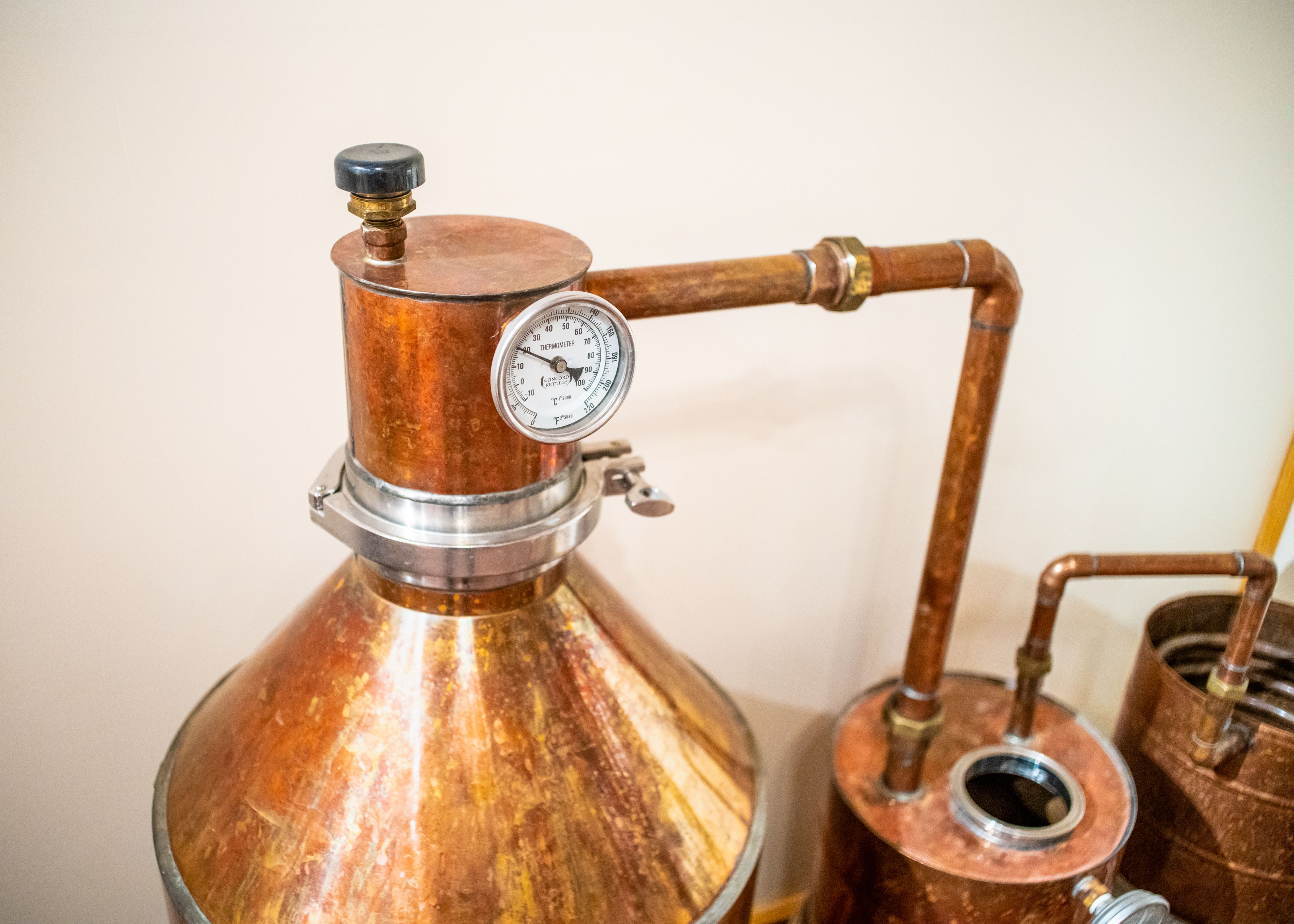 Copper equipment and a thermometer used in the whiskey-making process